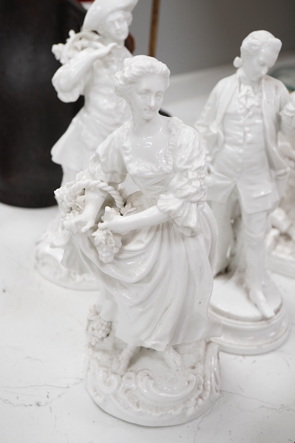 Three Continental white glazed figures and an English bone china group, tallest 25cm